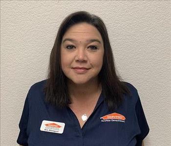 Female employee smiling in front of white back ground