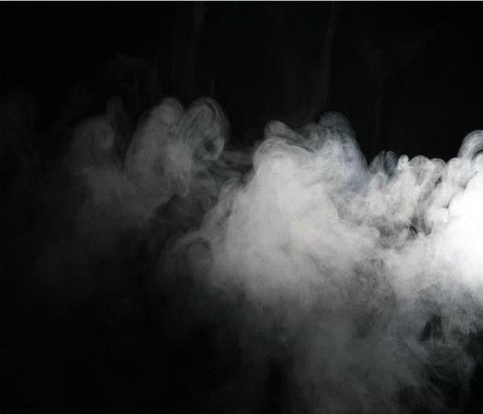White smoke billowing against a black background